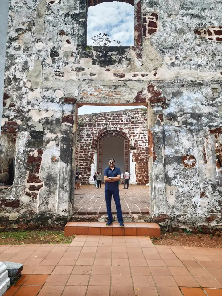Weathered laterite ruins of St Paul’s Church, Melaka, stacked doorways framing the courtyard beyond